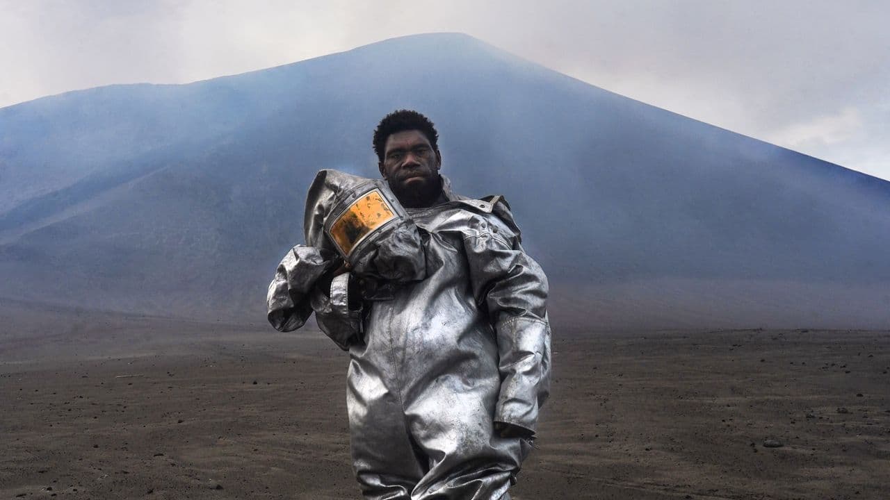 Vanuatu's 'barefoot volcanologist' stands at ash- and sulfur-spewing Mount Yasur in award-winning photograph